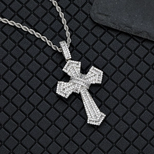 Macro shot of hip hop cross pendant with pave-set crystals on a twist rope chain
