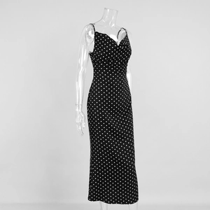 Detail of V-neckline and strap design on a black polka dot fishtail midi dress