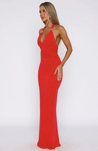 Detail of red halter maxi dress featuring a deep V-neck and decorative gold metal rings