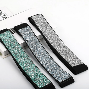 Detail of three elastic waistbands with green, blue and silver glitter sequins