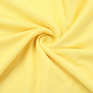 Gros plan sur la texture du tissu en maille jaune pour robes de soirée élégantes