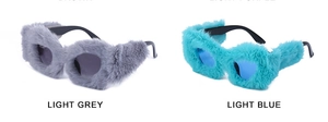 Detail of light grey and light blue heart-shaped sunglasses with plush faux fur frames