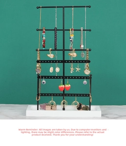Detail view of 6-tier black metal jewelry stand with necklace hooks and earring holes