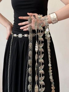Detail of silver bohemian waist chain with turquoise butterfly and metal link tassels