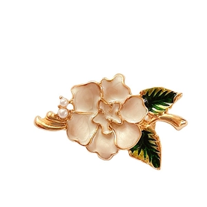 Vintage poppy flower brooch with enamel petals and pearls on a white background