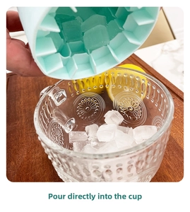 Silicone cylinder ice bucket showing easy release of ice cubes into a glass cup