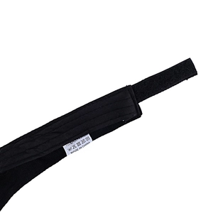Detail of adjustable hook and loop strap on black sports visor made of 100% polyester