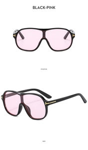 Detail of shield sunglasses showing black frames with pink lenses and metal hinges