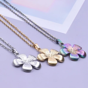 Three 18k plated stainless steel necklaces with flower pendants in gold silver and rainbow