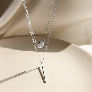 Double-layer sterling silver necklace featuring a zircon disc and geometric bar pendant