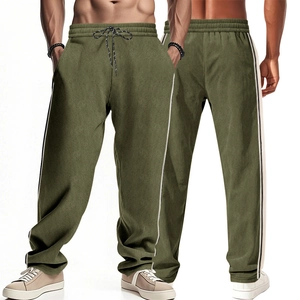 Detailed view of olive green corduroy pants with side stripes and drawstring waist