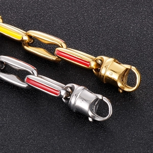 Macro detail of bicolored hip hop Cuban chain links with red and yellow enamel inlay