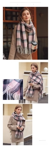 Close-up of pink and grey checkered winter scarf with soft tassels and woven texture