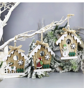 Detailed view of wood house ornaments with reindeer, santa and snowman hanging on a tree