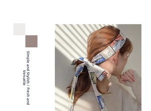 Close-up of a French style floral hair scarf with cute cat prints tied on a model