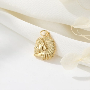 Close-up of a 14K gold-plated skull pendant with detailed Indian feather headdress