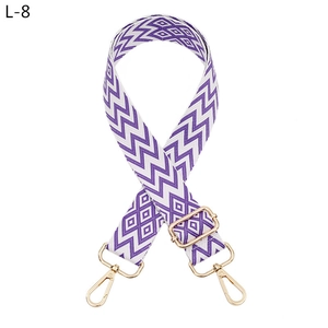 Detailed view of purple geometric jacquard woven strap with gold metal lobster clasps