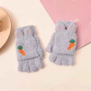 Detail of grey plush flip-top gloves with carrot knit decoration and furry texture