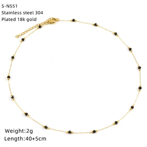 Detail of 18k gold plated stainless steel necklace with black glass beads and fine link chain