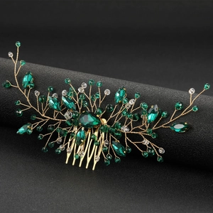Detailed close-up of emerald green crystal hair comb with gold floral wire accents