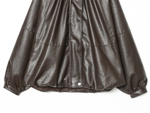 Close-up of the dark brown PU leather jacket showing hem and cuff texture details