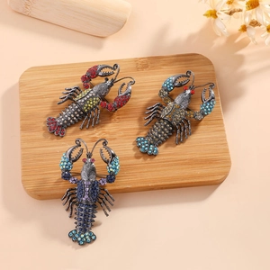 Detailed macro view of vintage lobster brooches with colorful rhinestones on wood