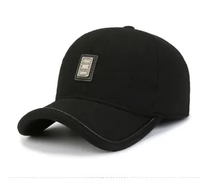 Detail of wool baseball cap with leather trim and decorative metal brand plate