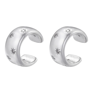 Detail of silver C-shaped ear cuffs featuring engraved star and sunburst texture