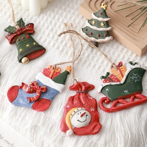 Hand-painted resin Christmas tree ornaments set with snowman and stocking on white blanket