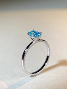 Macro detail of a 1 carat blue oval zircon gemstone in a S925 sterling silver four-prong setting