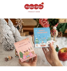 Detail of Christmas gift boxes with festive illustrations and gold rope handles
