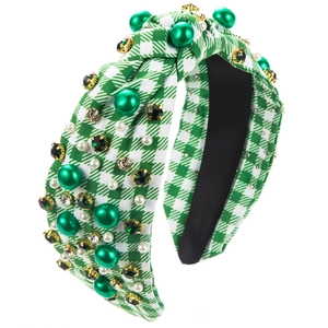 Detailed view of green and white plaid headband with faux pearls and crystals