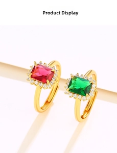 Detailed macro view of adjustable emerald and ruby ring set with sparkling CZ accents