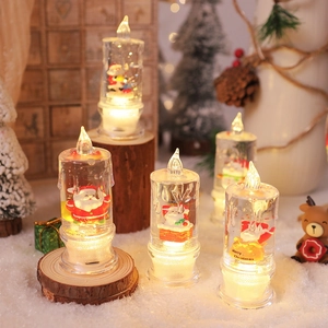 Close-up of LED Christmas candle with Santa Claus figure and warm white light glow