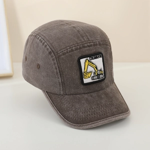 Detail of excavator embroidery and metal eyelet on dark grey denim kids cap