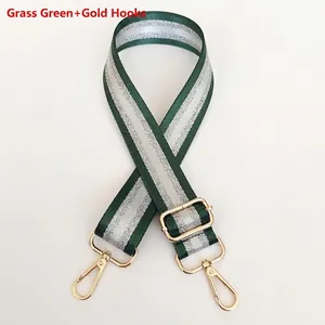 Detail of adjustable grass green and silver nylon bag strap with gold metal swivel hooks