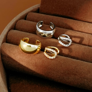 Detail of 18k gold and silver plated ear cuffs with cubic zirconia in a velvet box