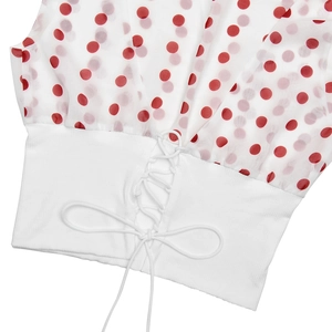 Detail of white and red polka dot crop top featuring sheer chiffon sleeves and waist ties