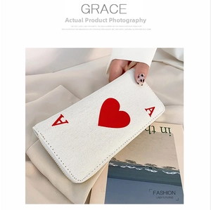 Detail of Ace of Hearts long canvas wallet featuring smooth zip and fabric texture