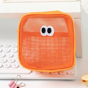 Close-up of orange mesh organizer bag featuring large cartoon eye embroidery detail