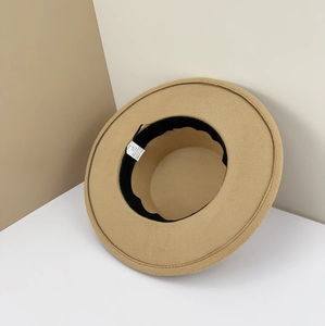 Detail view of the camel felt hat interior showing the size label and blend fabric