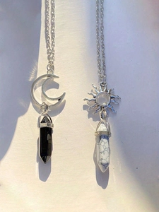 Detail of sun and moon pendants with hexagonal crystal stone points on chain necklaces