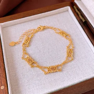 French vintage gold hollow floral bracelet with adjustable chain in a wooden jewelry box