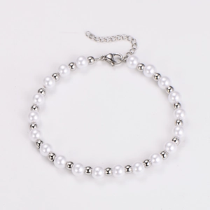 Close-up of white pearls and silver metal beads bracelet with lobster clasp detail