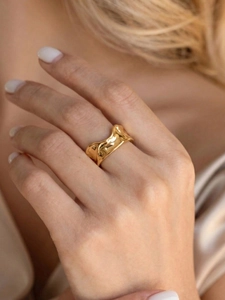 Detailed view of the 18K gold irregular wavy ring featuring a liquid metal texture finish