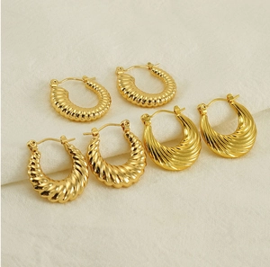 Detailed view of three styles of textured 18K gold plated stainless steel hoop earrings