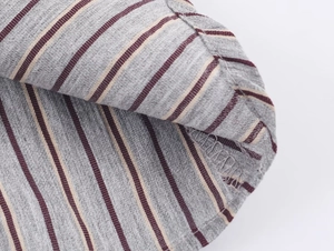 Macro shot of striped cotton fabric showing seam details and grey texture with red lines