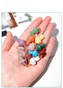 Macro shot of assorted colorful mushroom crystal pendants with golden metal loops