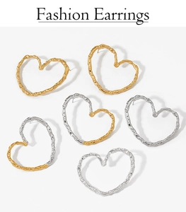 Detail of heart earrings in gold and silver with hammer-textured 316L stainless steel