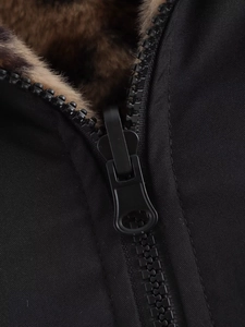 Close-up of the zipper closure and fluffy faux fur lining on a black winter pilot jacket